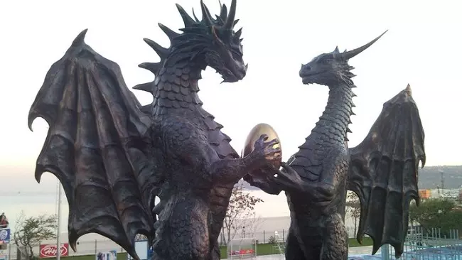 Statues of male and female dragons holding a dragon egg at Varna seaside